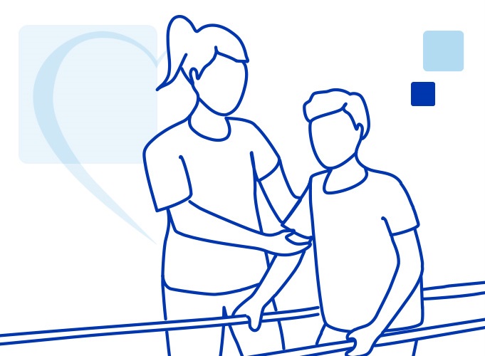 Adult male patient takes his first steps after foot surgery using the orthopedic parallel bars under the guidance of the female physical therapist.