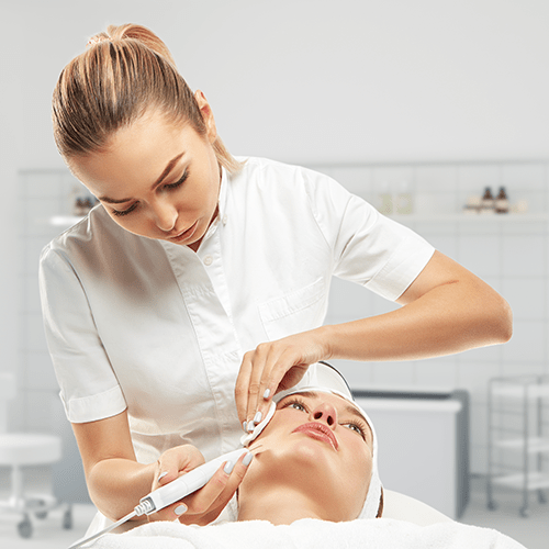 Esthetician providing services to patient.